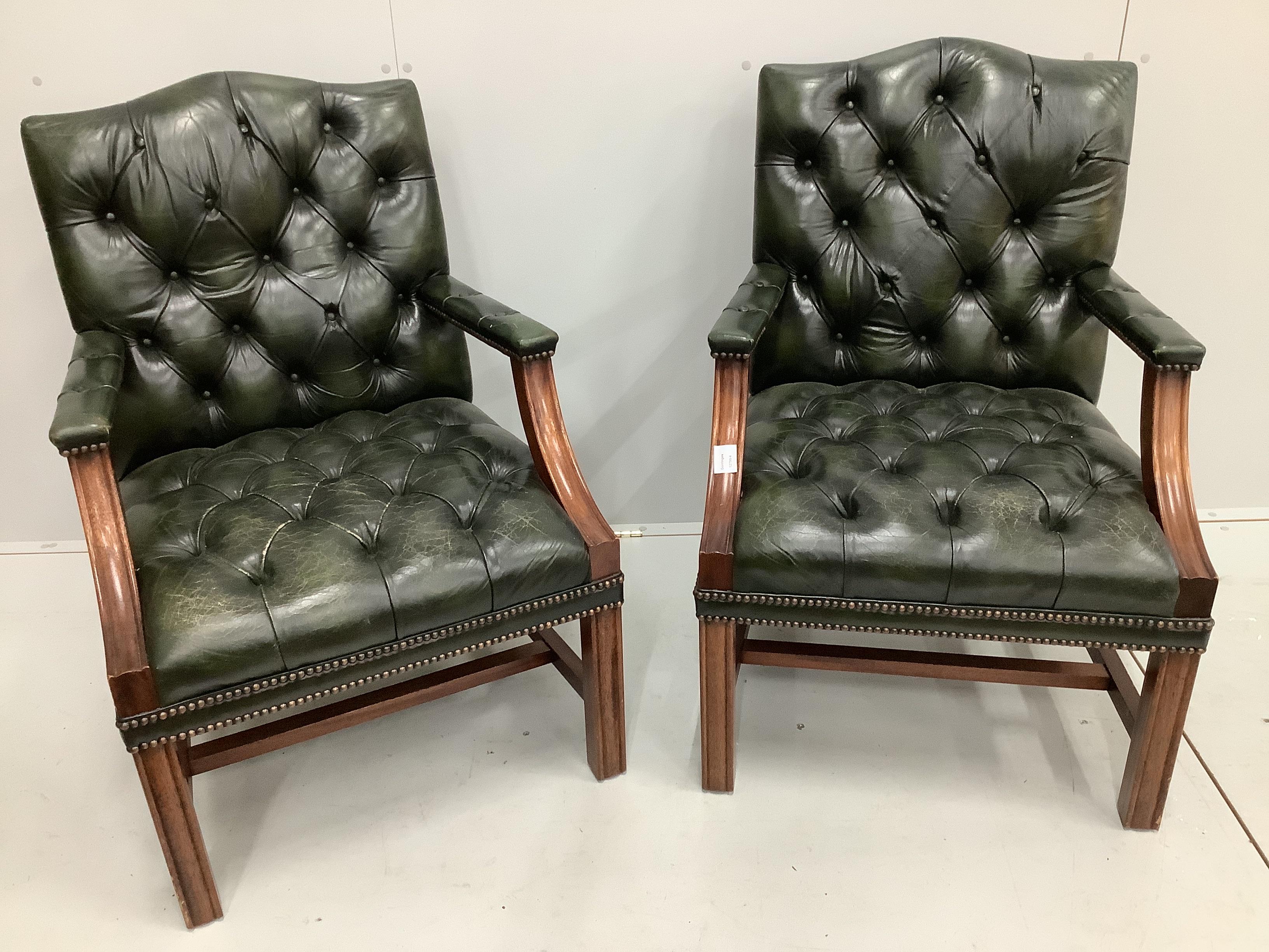 A pair of reproduction Gainsborough style buttoned green leather elbow chairs, width 63cm, depth 54cm, height 91cm